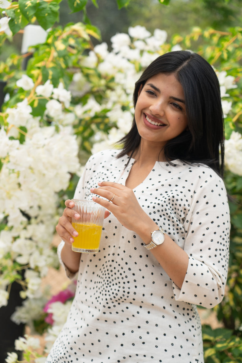 White polka short top with black pattern trousers